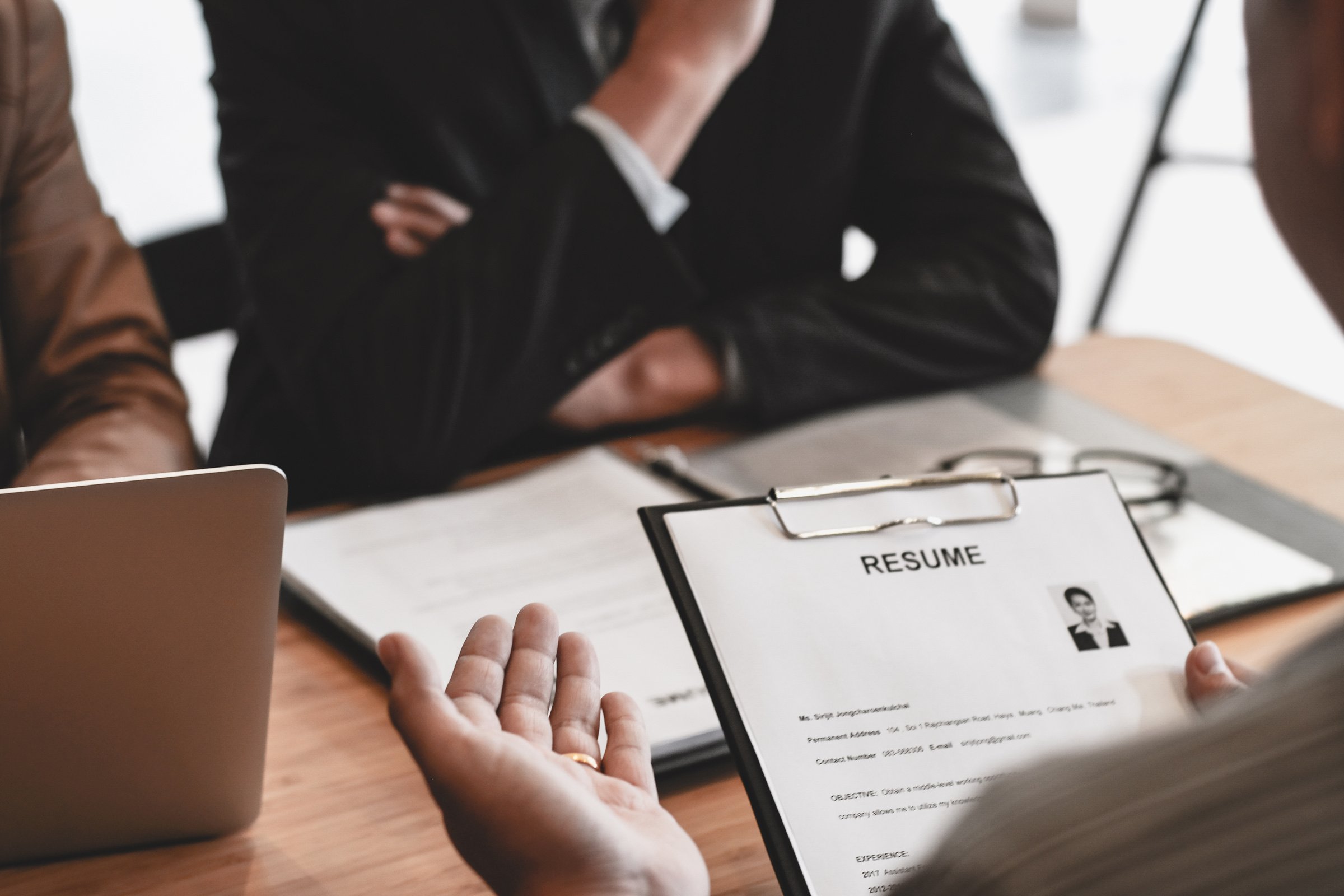 Examiner Reading a Resume during Job Interview at Office Busines